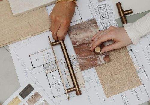 A team compares tile and color samples on an architectural board, using rulers and swatches to plan layout and finishes.