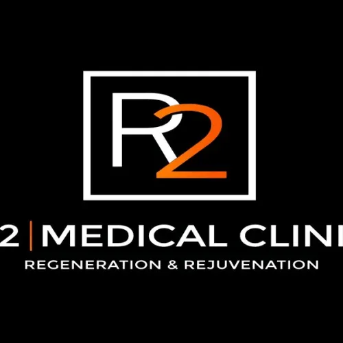 R2 Medical Clinic logo with an &ldquo;R2&rdquo; emblem and tagline &ldquo;Regeneration & Rejuvenation&rdquo; on a black background.