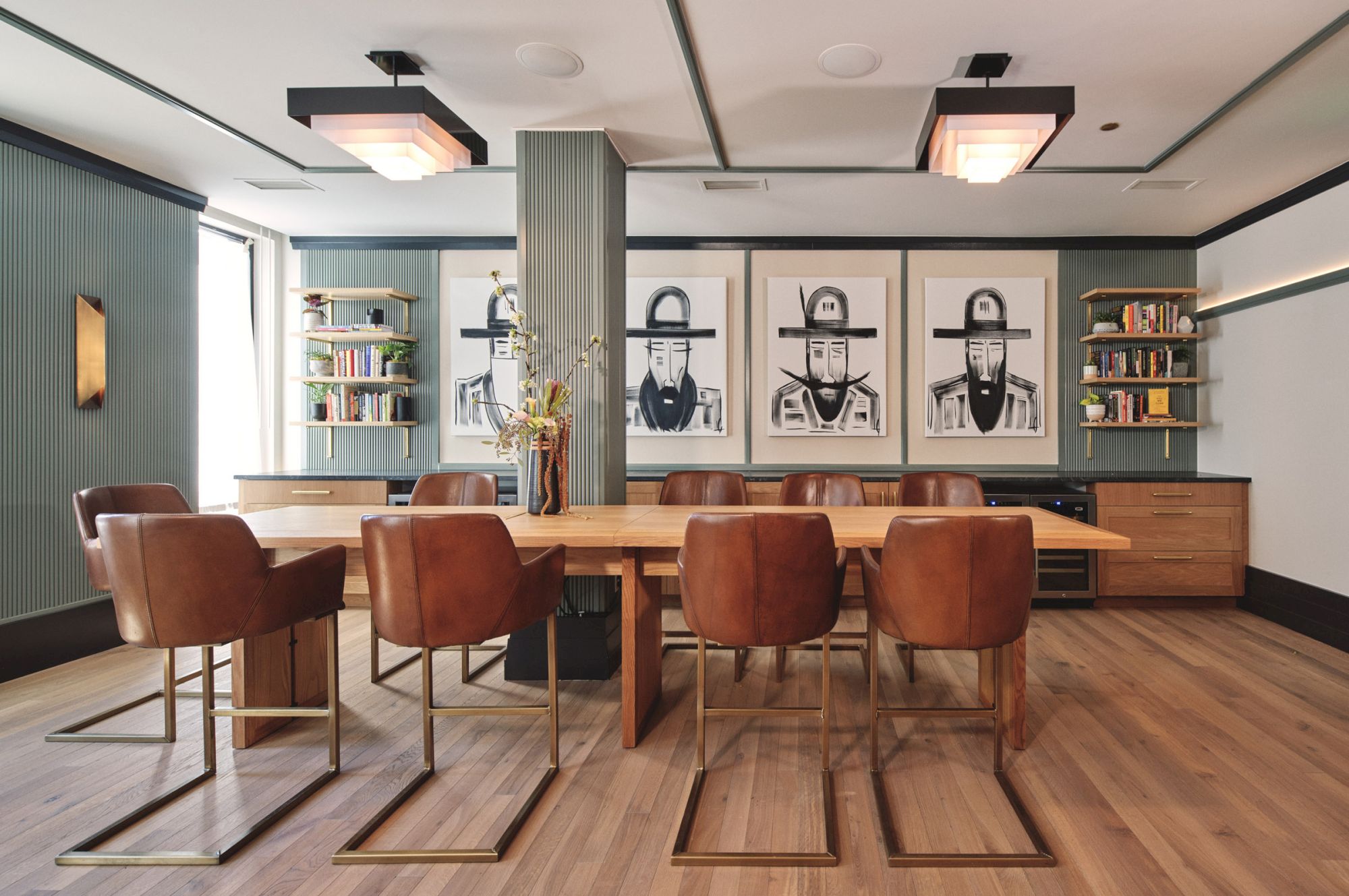 A stylish conference room with brown chairs, a large table, bookshelves, and modern art on the walls is shown.
