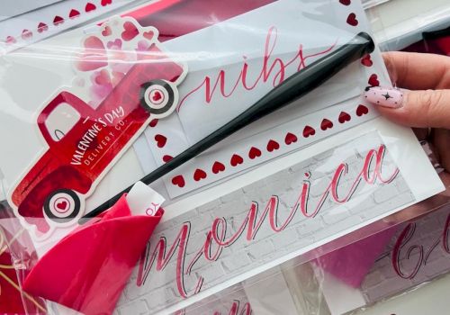 Valentine-themed gift set with pink cards, heart stickers, a small red toy car, and pink ribbon, all in clear packaging with names.